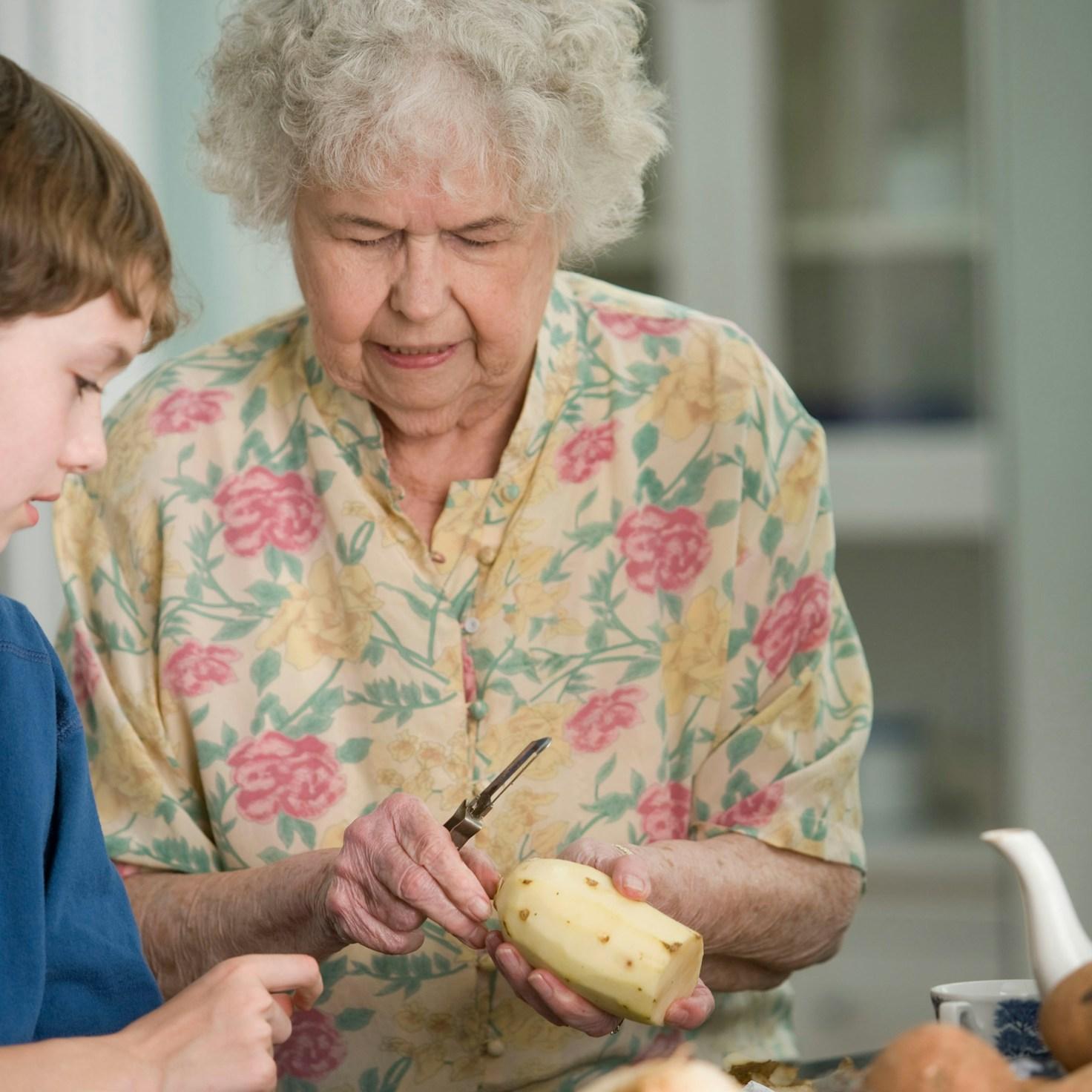 Friends working together in a contemporary kitchen, trading recipes and methods